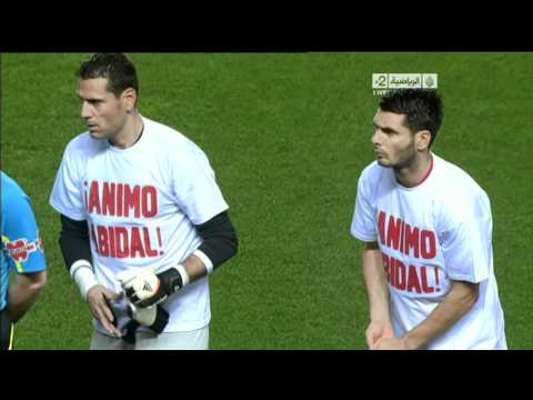 Barcelona and Sevilla players wearing Eric Abidal Shirts